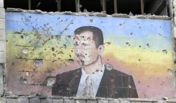 رسم-صورة-بشار-الأسد-جدار-حلب-رصاص-دمار