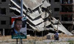 صورة بشار الأسد بين الدمار