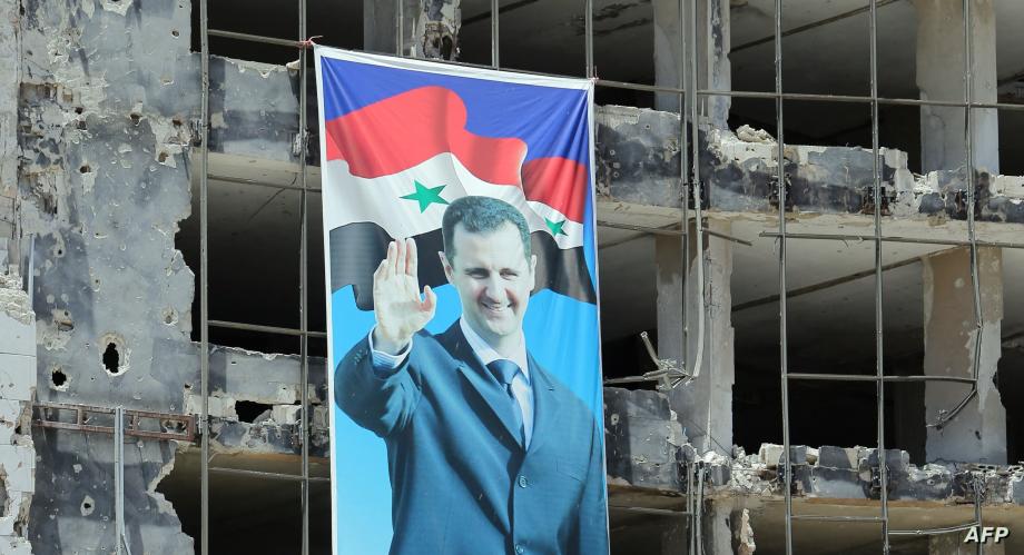 صورة بشار الأسد بين الدمار الذي أحدثته قصف ميليشياته